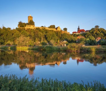 Schoenburg castle and village in the Saale valley in the evening light, reflection in the river