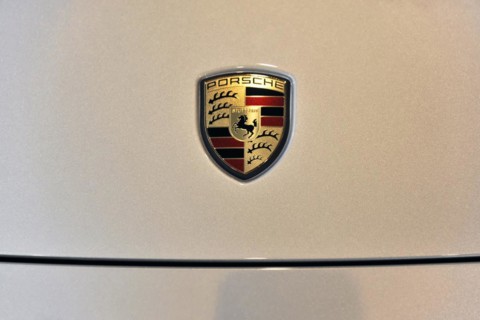 Close-up of the metallic Porsche emblem on a car, Schwaebisch Gmuend, Baden-Wuerttemberg, Germany,