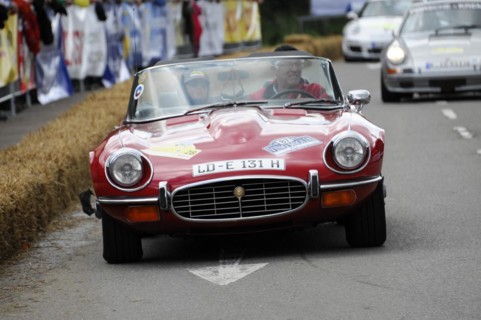 A red Jaguar E-Type convertible drives on a closed-off race track, SOLITUDE REVIVAL 2011,