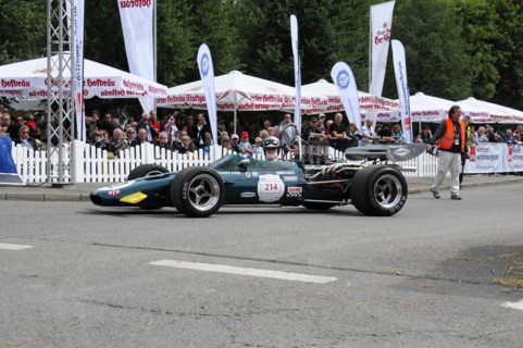 A green formula racing car on a race track driven by a driver, SOLITUDE REVIVAL 2011, Stuttgart,