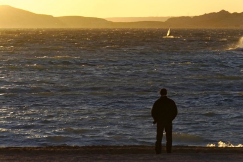 Marseille in the evening, A person stands on the shore and looks at the sea during sunset,