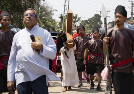 Christian devotees takes part in a perform to re-enactment of the crucifixion of Jesus Christ