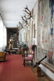 Langenburg Castle, view of a corridor with historical artefacts and hunting trophies on the walls,