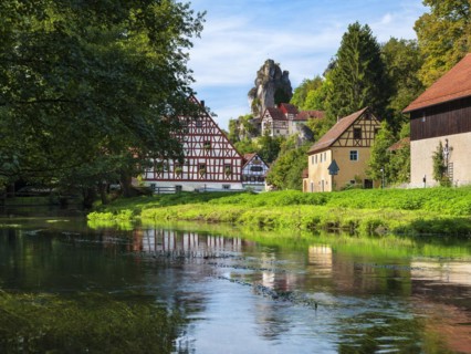 Zechenstein rock formation and half-timbered houses on the Puettlach river, rock castle and