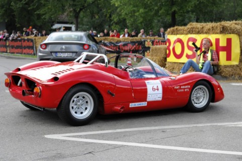 Rear view of a red Fiat Abarth racing car on a race track with straw bales, SOLITUDE REVIVAL 2011,