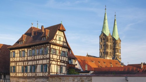 Towers of Bamberg Cathedral and half-timbered house in the evening light, Bamberg, Upper Franconia,