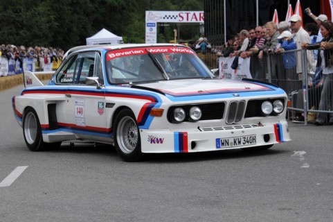 A BMW racing car in classic design on a race track surrounded by fans, SOLITUDE REVIVAL 2011,