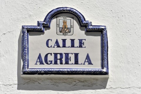 Solabrena, ceramic street sign with blue ornaments and heraldic coat of arms on a white wall, Costa