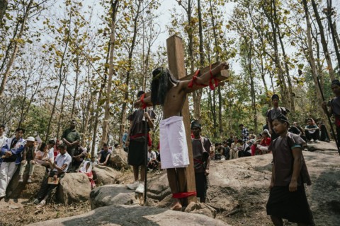 Christian devotees takes part in a perform to re-enactment of the crucifixion of Jesus Christ