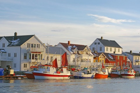 Fishing vessels in the last light of day in the harbour of Henningsvaer, Winter, Lofoten, Nordland,