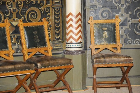 Langenburg Castle, Wooden chairs with leather seats and golden ornaments in a historic interior,