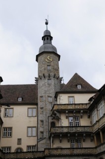 Langenburg Castle, The tower of a castle with a clock and decorations, in front of a cloudy sky,
