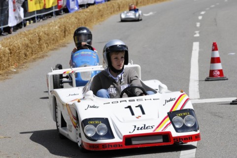 A racing driver in a white miniature racing car takes part in a race, SOLITUDE REVIVAL 2011,