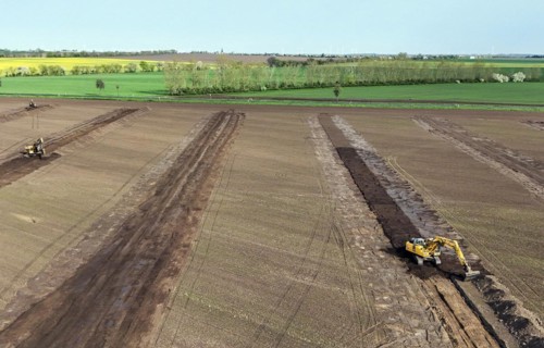 Excavators begin preparations for the construction site access road on the L 50 at the future Intel