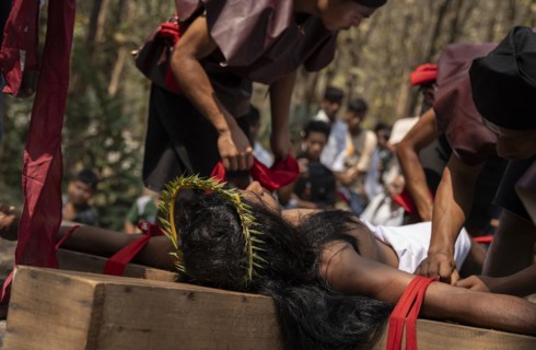 Christian devotees takes part in a perform to re-enactment of the crucifixion of Jesus Christ