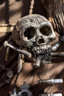 Old entrance door whimsically decorated, skull, engine parts, cartridge cases, tools, old town,