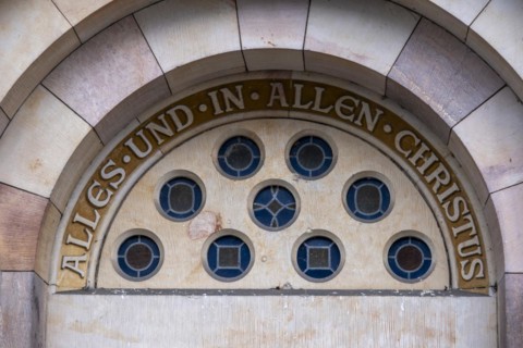 Slogan All and in all Christ above a door of St Mary's Cathedral, Havelberg, Saxony-Anhalt,