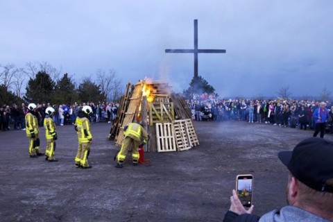 The fire brigade lights the Easter bonfire on the Haniel spoil tip in front of the summit cross,