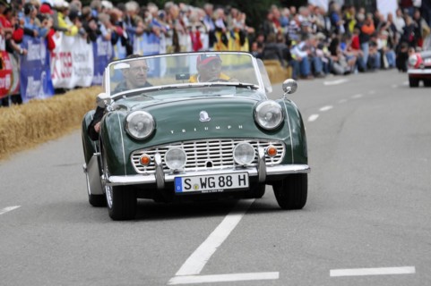 A green classic roadster drives on a road at a classic car race, SOLITUDE REVIVAL 2011, Stuttgart,