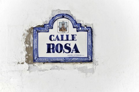 Solabrena, A white and blue ceramic sign on a wall shows 'Calle Rosa' as the street name,