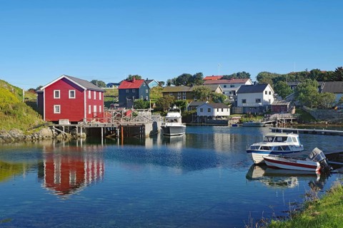 Small houses and boats in a sheltered bay, Lovunden, Helgeland coast, Traena, Norway, Europe