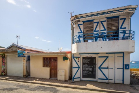 Deshaies, historic Caribbean wooden building of a street in Guadeloupe, Caribbean, French Antilles
