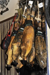 Jaen, Several cured hams hanging from ceiling hooks in a Spanish shop, Jaen, Andalusia, Spain,