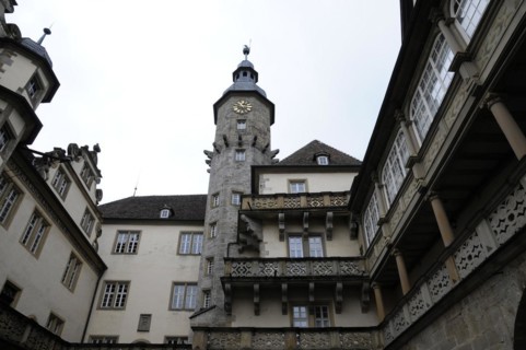 Langenburg Castle, A view of a castle with a tower and half-timbered elements under a grey sky,