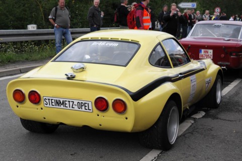 Rear end of a yellow vintage coupe with racing numbers and spectators, SOLITUDE REVIVAL 2011,