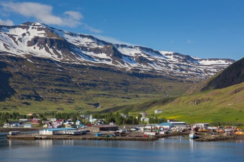 View over harbour and town Seyoisfjoerour along the fjord Seydisfjoerdur in summer, Eastern Region,