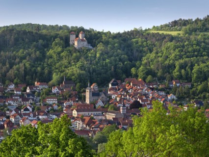 View of the town of Treffurt in the Werra Valley and Normannstein Castle in the evening light,