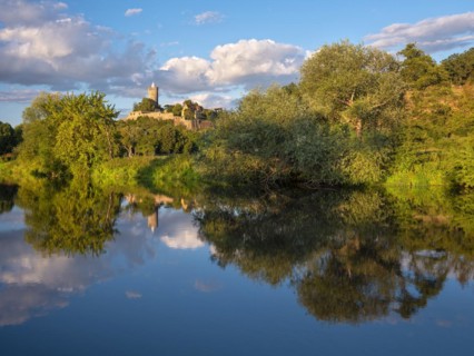 Schoenburg Castle in the Saale valley in the evening light, reflection in the river Saale,