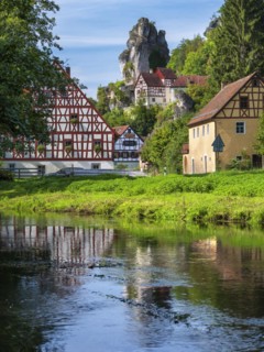 Zechenstein rock formation and half-timbered houses on the Puettlach river, rock castle and