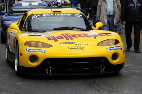 A yellow racing car with advertising stickers and the Michelin logo, SOLITUDE REVIVAL 2011,