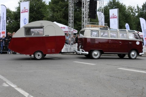 Side view of a VW bus with caravan in front of a crowd of spectators, SOLITUDE REVIVAL 2011,
