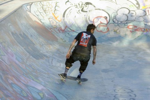 Teenager skateboarding on a ramp in a skate park decorated with graffiti, Marseille,