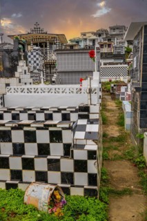 Famous cemetery, many mausoleums or large tombs decorated with tiles, often in black and white.