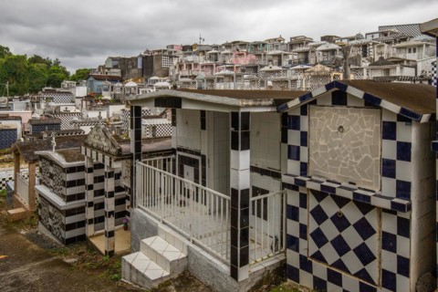 Famous cemetery, many mausoleums or large tombs decorated with tiles, often in black and white.