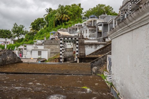 Famous cemetery, many mausoleums or large tombs decorated with tiles, often in black and white.