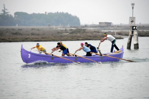 Burano, Burano Island, A group of rowers in a competition on calm water, Burano, Venice, Veneto,
