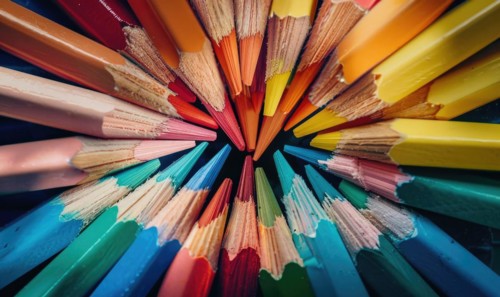 An overhead shot of colored pencils arranged in a pattern, abstract background with colored pencils