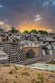 Famous cemetery, many mausoleums or large tombs decorated with tiles, often in black and white.