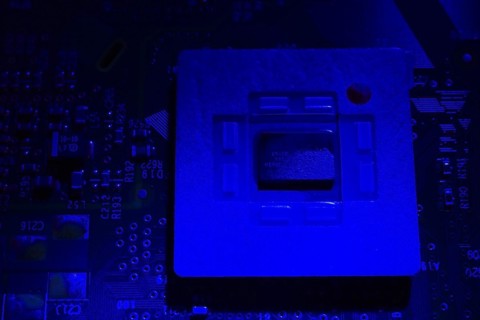 Close-up of blue lighted microchip on electronic computer circuit board, Studio Composition,