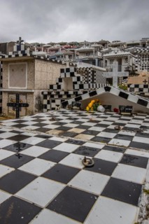 Famous cemetery, many mausoleums or large tombs decorated with tiles, often in black and white.