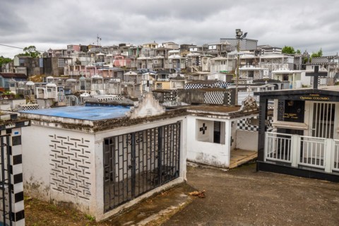 Famous cemetery, many mausoleums or large tombs decorated with tiles, often in black and white.