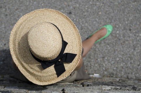 Woman with Straw Hat and Green Shoes and Leaning on the Wall