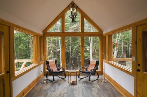 Reading room with tan and dark grey nuanced ceramic tile floor and two black leather rocking chairs