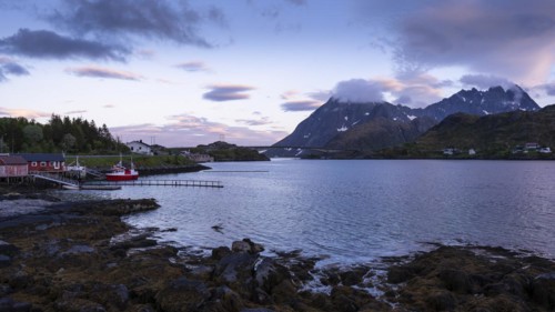 Landscape on the Lofoten Islands near Ramberg. On the left a few houses by the sea and a boat.