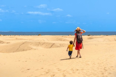 Mother and child on summer vacation in the dunes of Maspalomas, Gran Canaria, Canary Islands