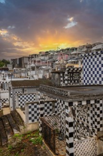 Famous cemetery, many mausoleums or large tombs decorated with tiles, often in black and white.